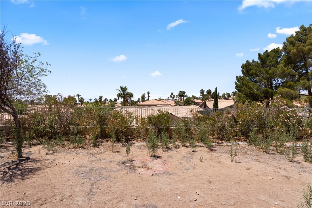 649 Rancho Circle Mesquite, NV 89027 - Photo 55 of 73 This elevated view captures distant rooftops and lush trees under an expansive blue sky.