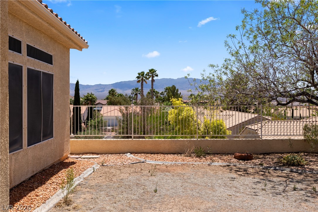 649 Rancho Circle Mesquite, NV 89027 - Photo 57 of 73 This spacious backyard offers tranquil desert and mountain views under a bright blue sky.