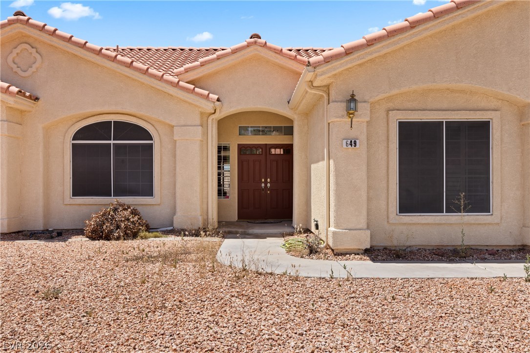 649 Rancho Circle Mesquite, NV 89027 - Photo 58 of 73 This residence presents an appealing facade with architectural detailing and a welcoming entryway.