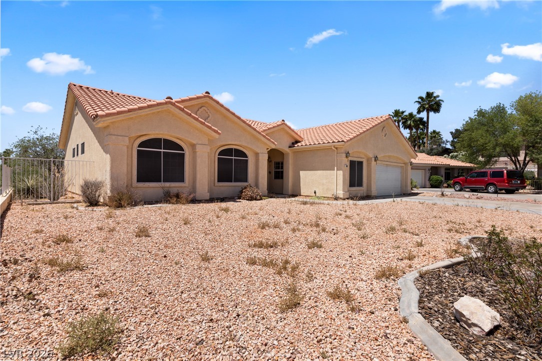 649 Rancho Circle Mesquite, NV 89027 - Photo 63 of 73 This desert dwelling offers a classic Southwestern facade with an attached garage and practical, low-maintenance landscaping.