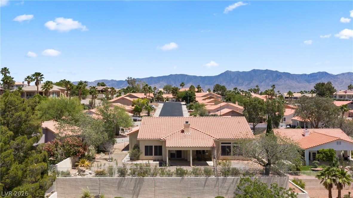 649 Rancho Circle Mesquite, NV 89027 - Photo 68 of 73 This elevated view captures a serene neighborhood nestled against majestic mountains, showcasing a tiled roof home.