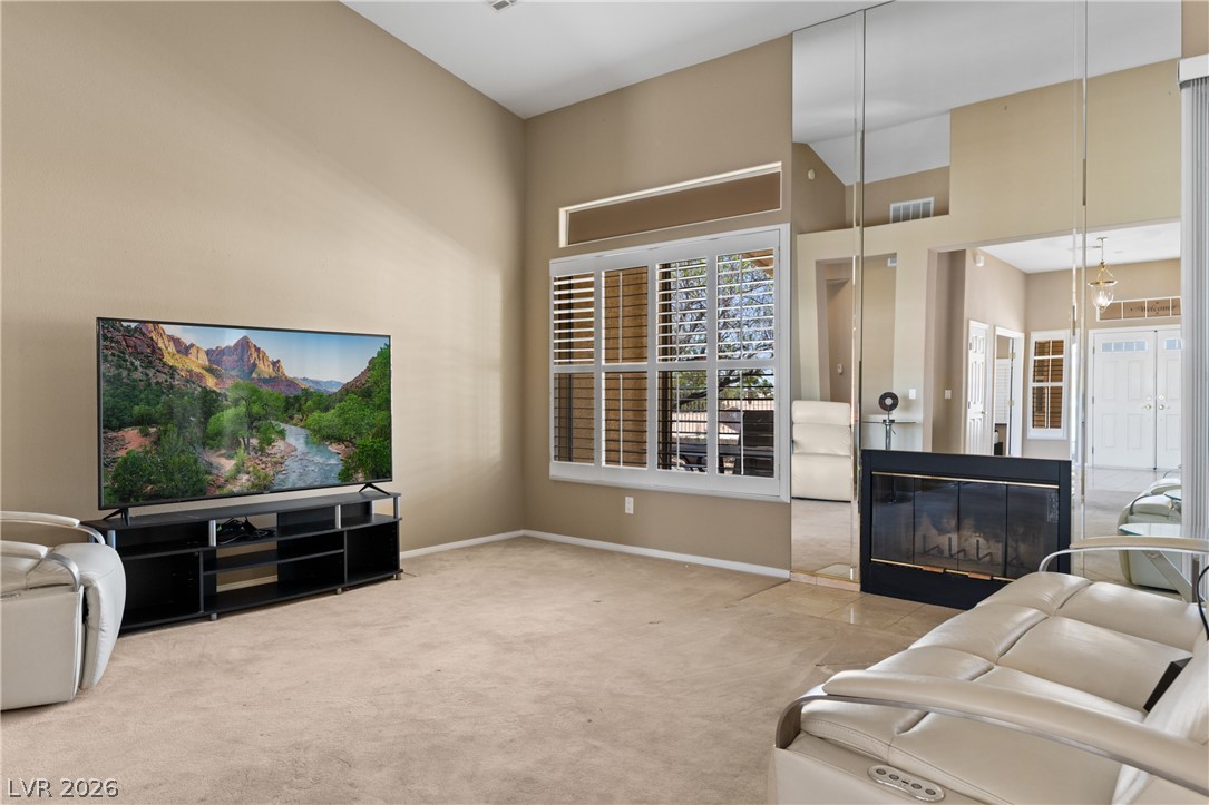 649 Rancho Circle Mesquite, NV 89027 - Photo 8 of 73 This inviting living area features a fireplace and natural light, perfect for relaxation and gatherings.