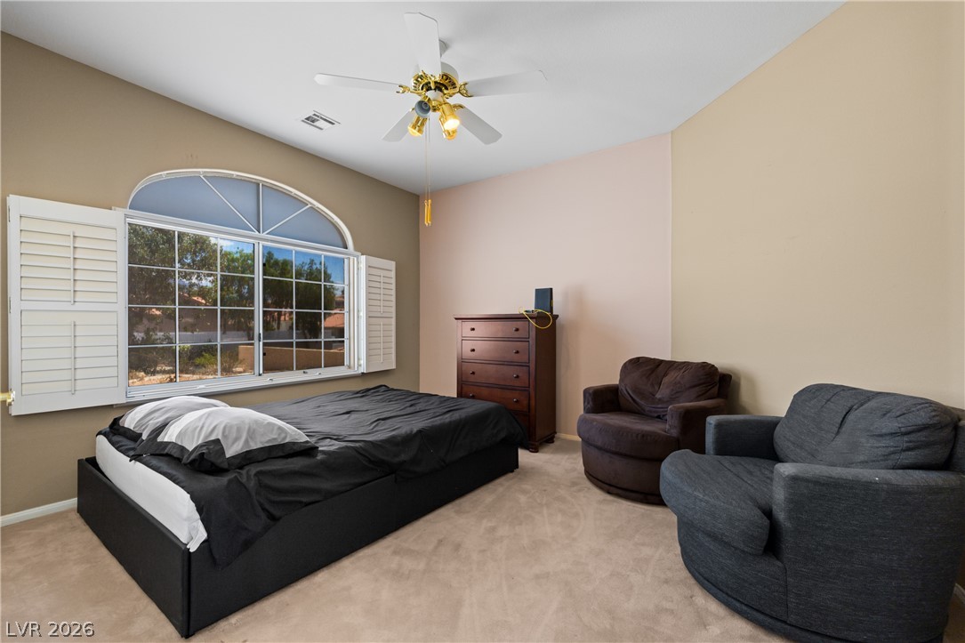 649 Rancho Circle Mesquite, NV 89027 - Photo 10 of 73 This spacious bedroom offers ample light and comfort for peaceful repose.