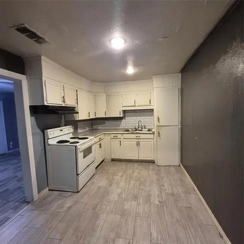 a kitchen with a white cabinets and white appliances