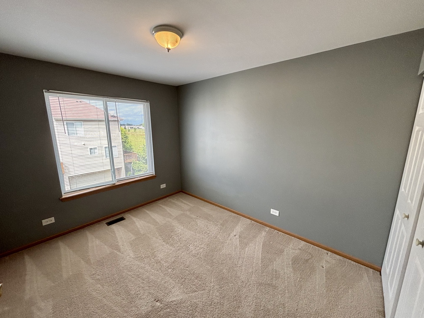 906 Clover Lane, Unit 906 Pingree Grove, IL 60140 - Photo 23 of 37 an empty room with windows