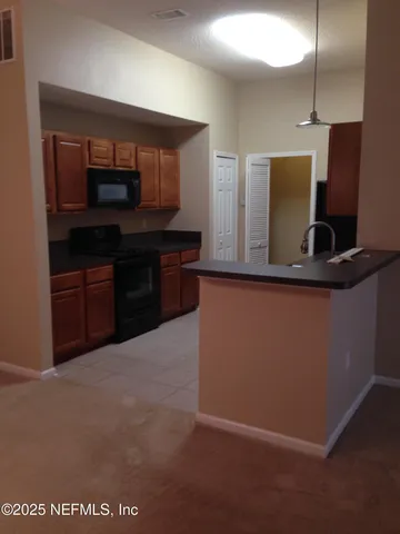 a kitchen with stainless steel appliances granite countertop a refrigerator and a stove