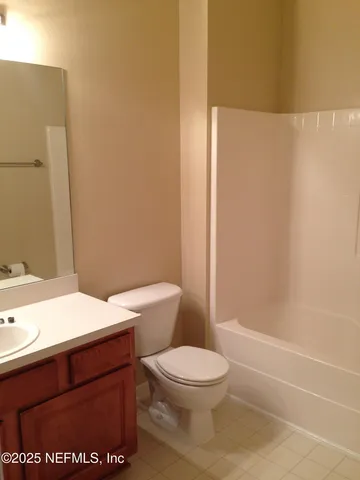 a bathroom with a toilet a sink and shower