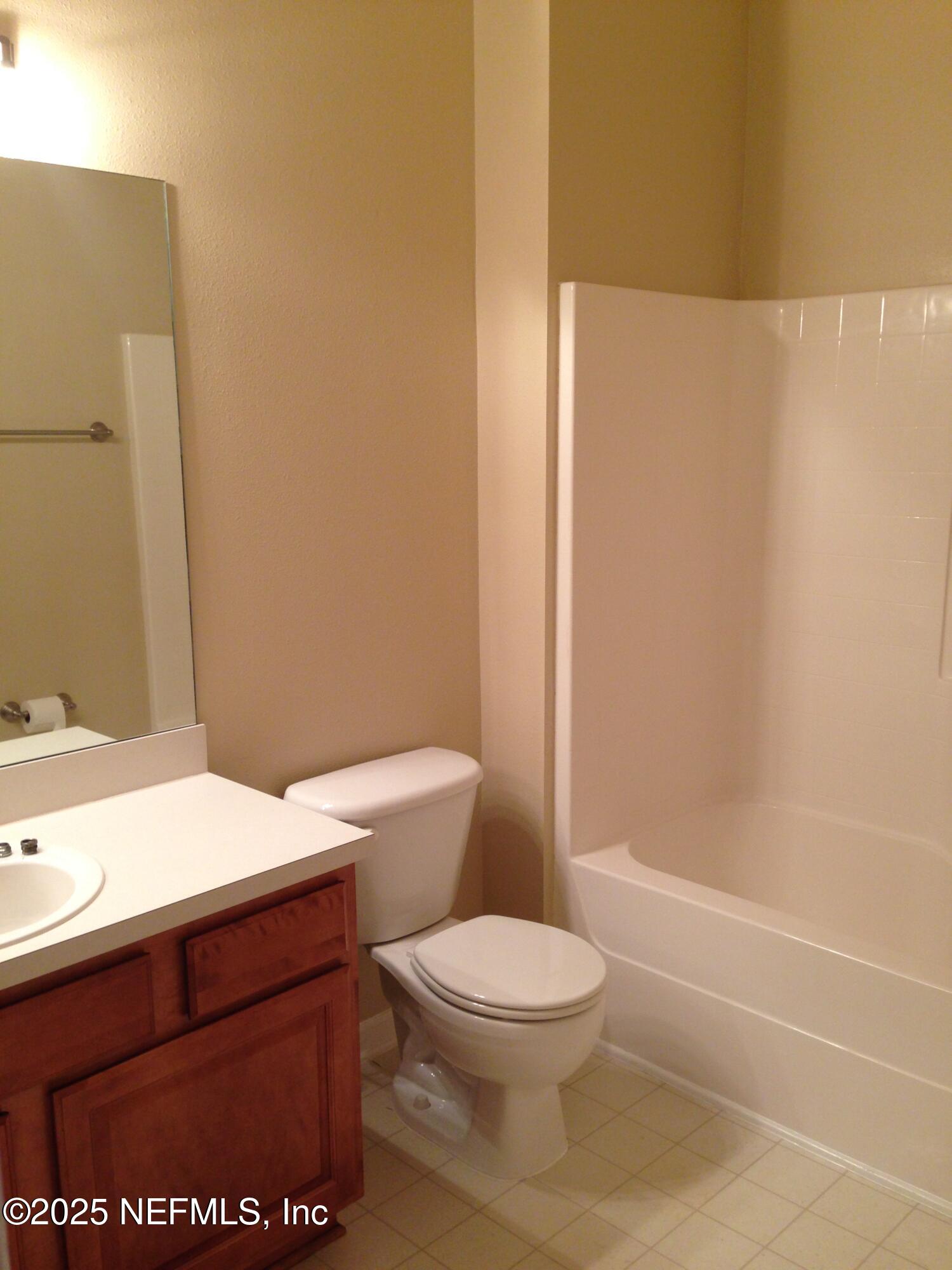 9625 Amarante Way, Unit 6 Jacksonville, FL 32257 - Photo 14 of 17 a bathroom with a toilet a sink and shower