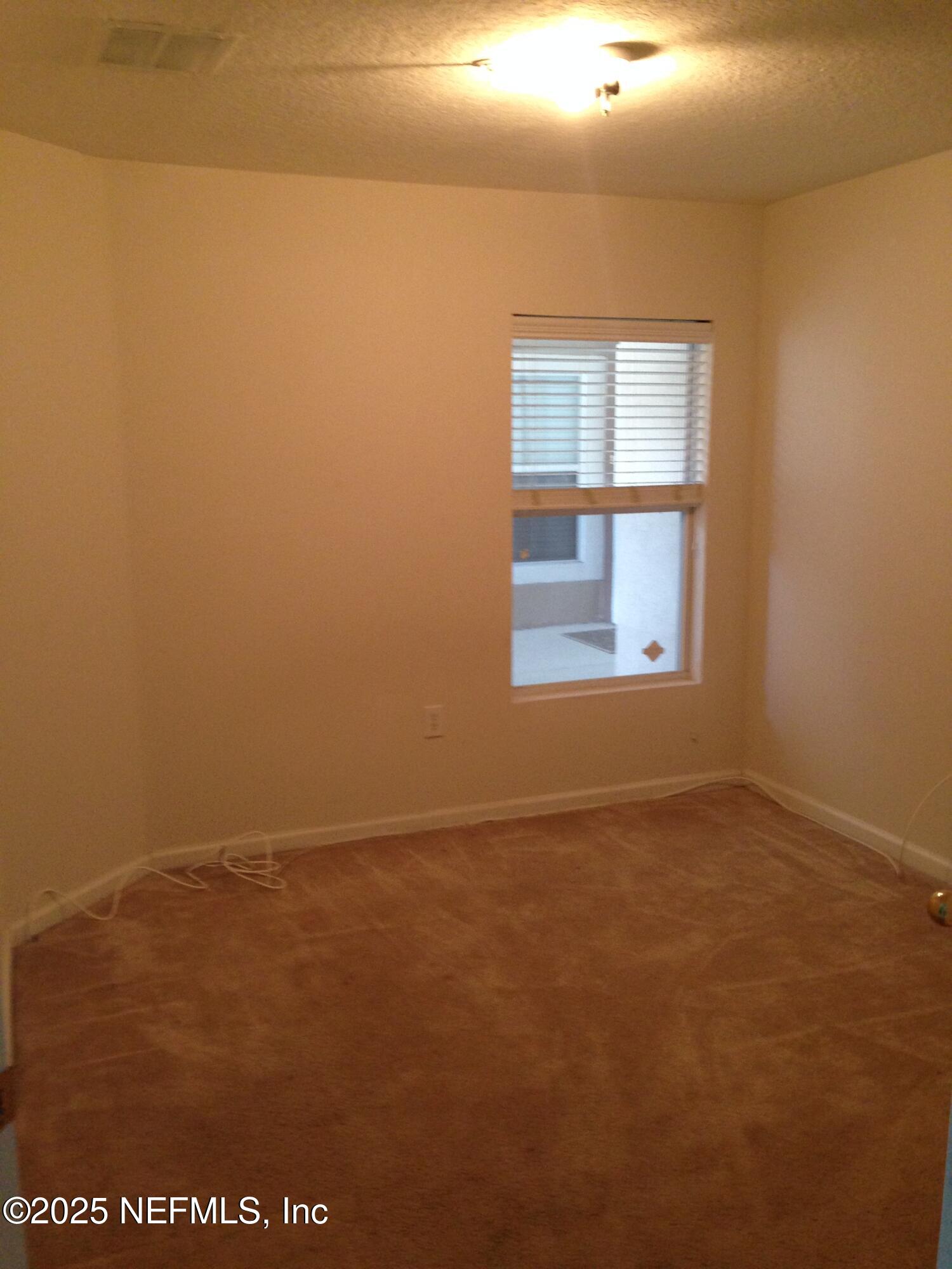 9625 Amarante Way, Unit 6 Jacksonville, FL 32257 - Photo 17 of 17 an empty room with a window