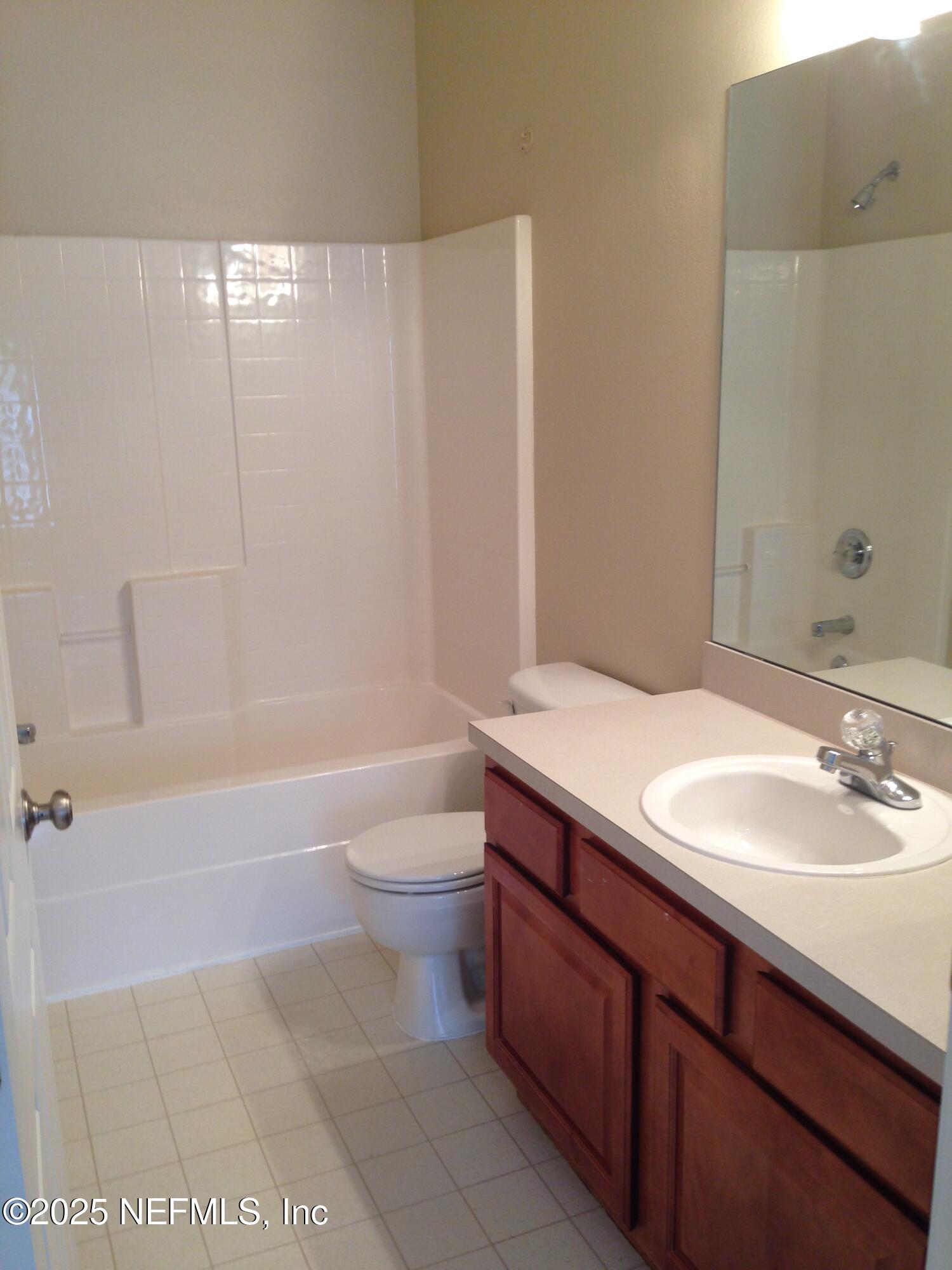 9625 Amarante Way, Unit 6 Jacksonville, FL 32257 - Photo 6 of 17 a bathroom with a sink a toilet and shower