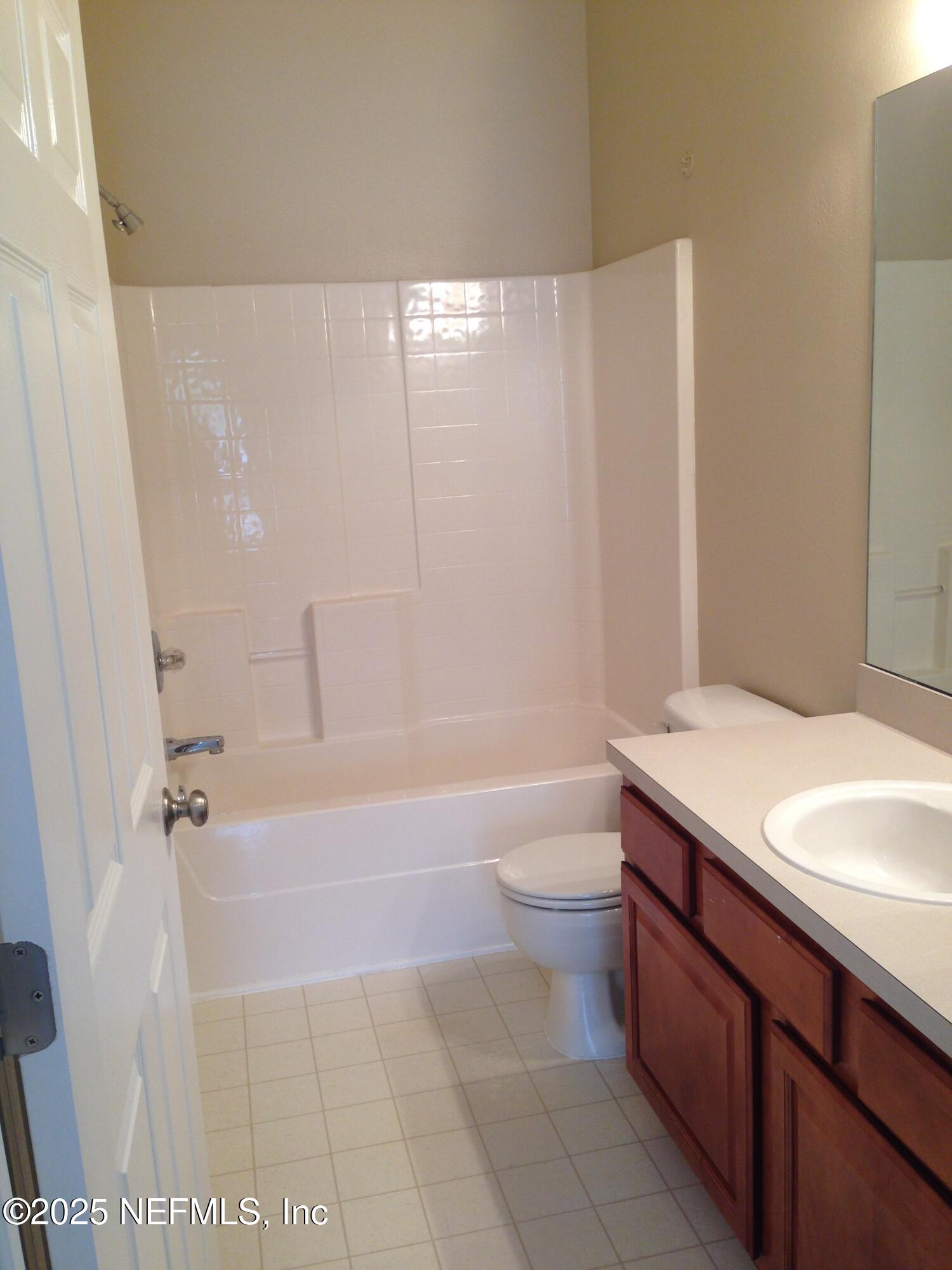 9625 Amarante Way, Unit 6 Jacksonville, FL 32257 - Photo 7 of 17 a bathroom with a sink a toilet and shower