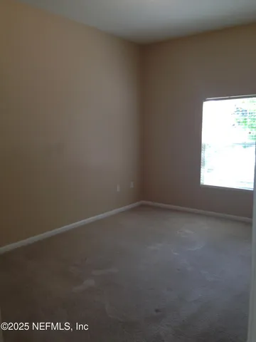 a view of an empty room and a window