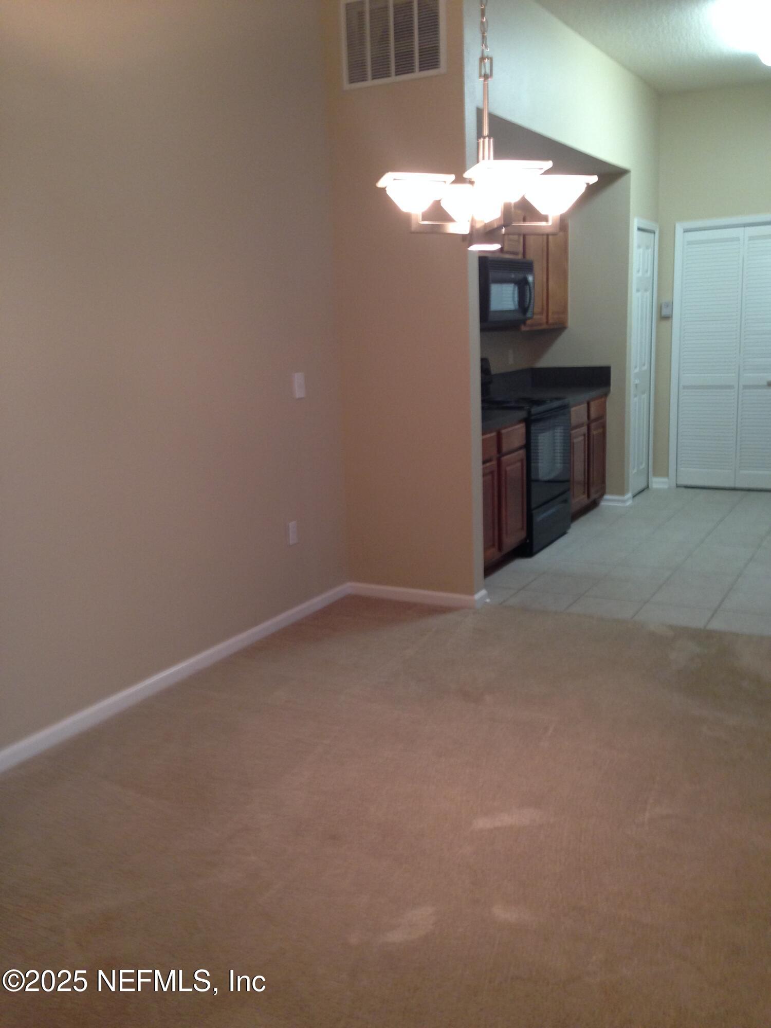 9625 Amarante Way, Unit 6 Jacksonville, FL 32257 - Photo 10 of 17 a view of a hallway with a chandelier