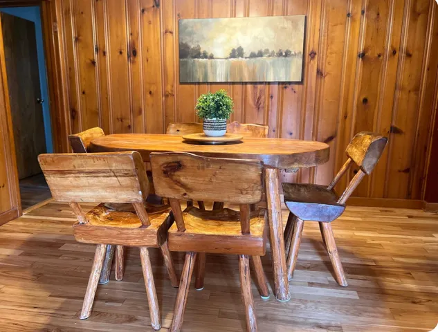 a dining room with furniture and wooden floor