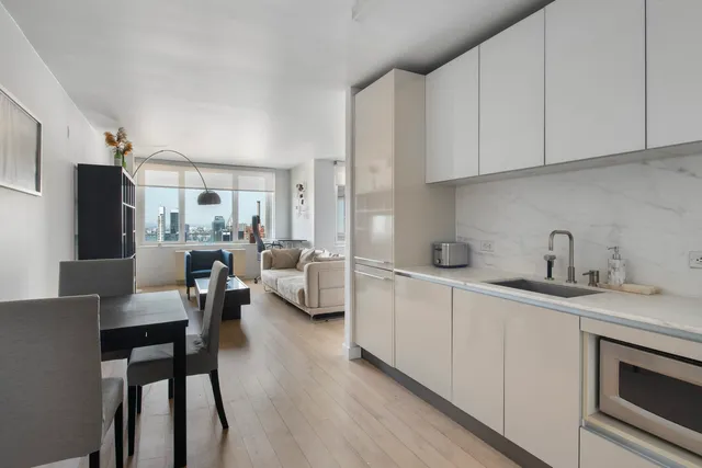 a kitchen with white cabinets and white appliances