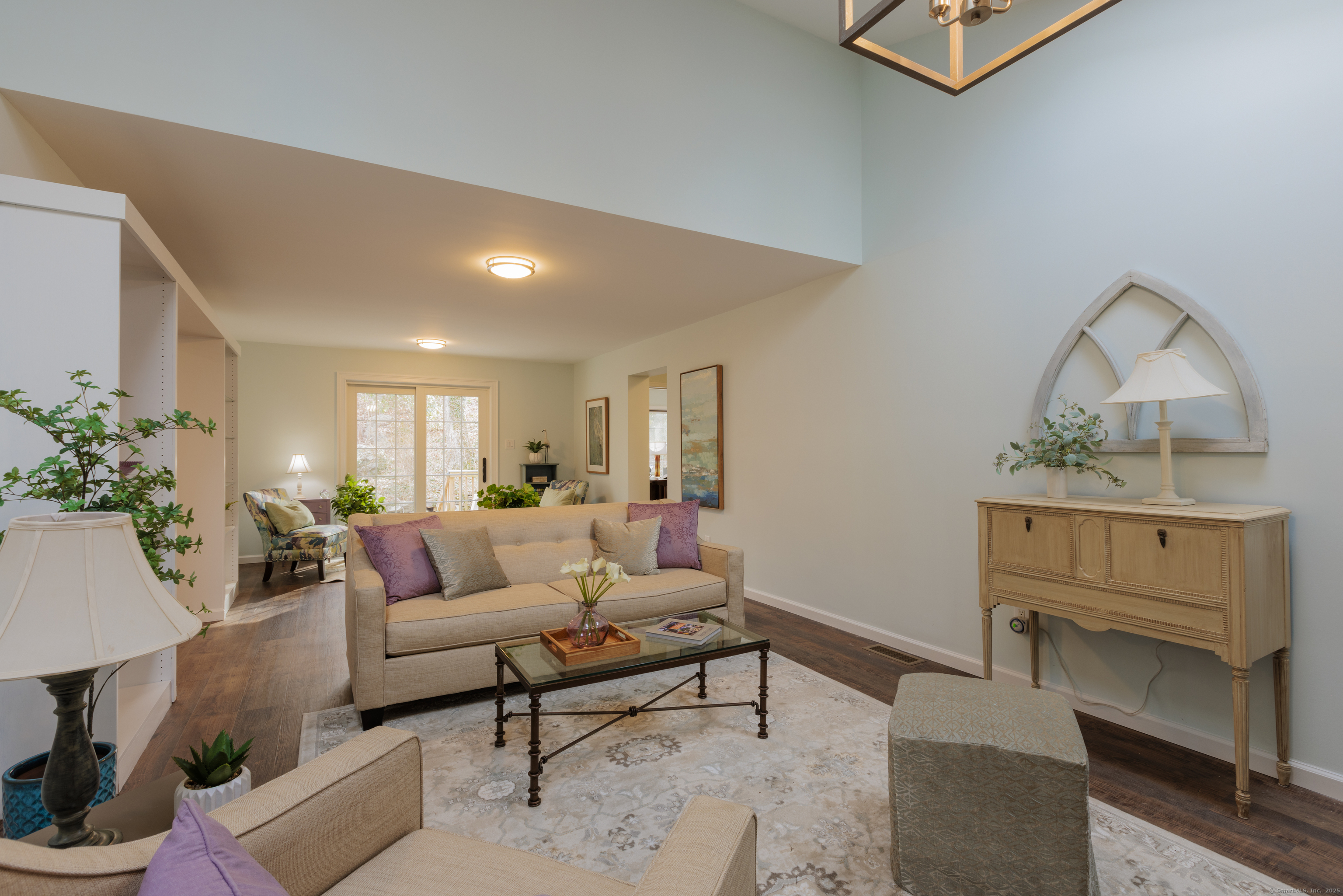 a living room with furniture and a potted plant