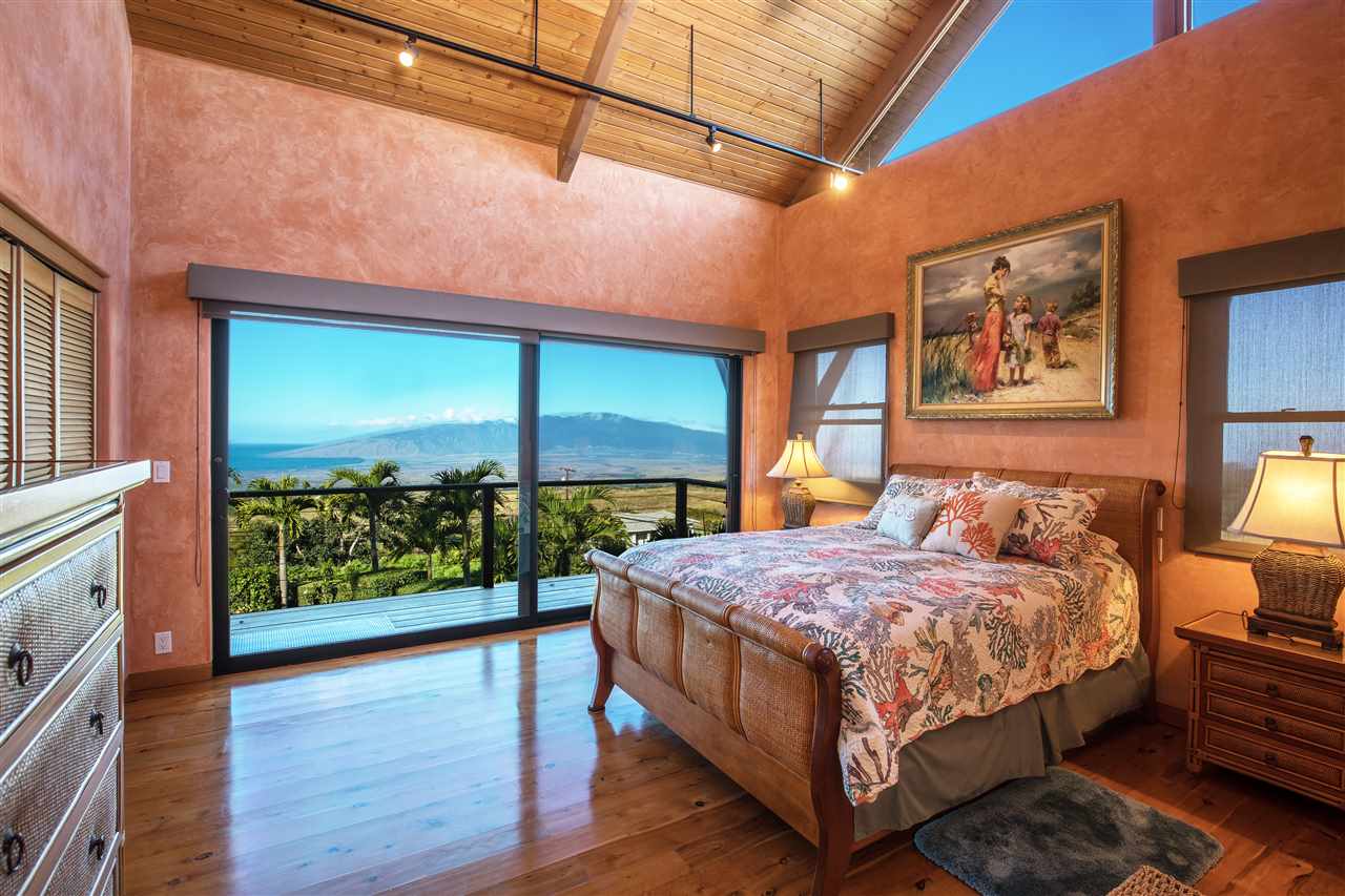 2623 Lower Kula Road Kula, HI 96790 - Photo 17 of 29 a bedroom with a bed and large window