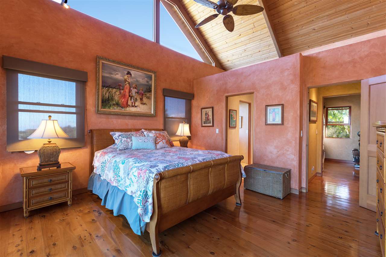2623 Lower Kula Road Kula, HI 96790 - Photo 18 of 29 a bedroom with a bed and wooden floor