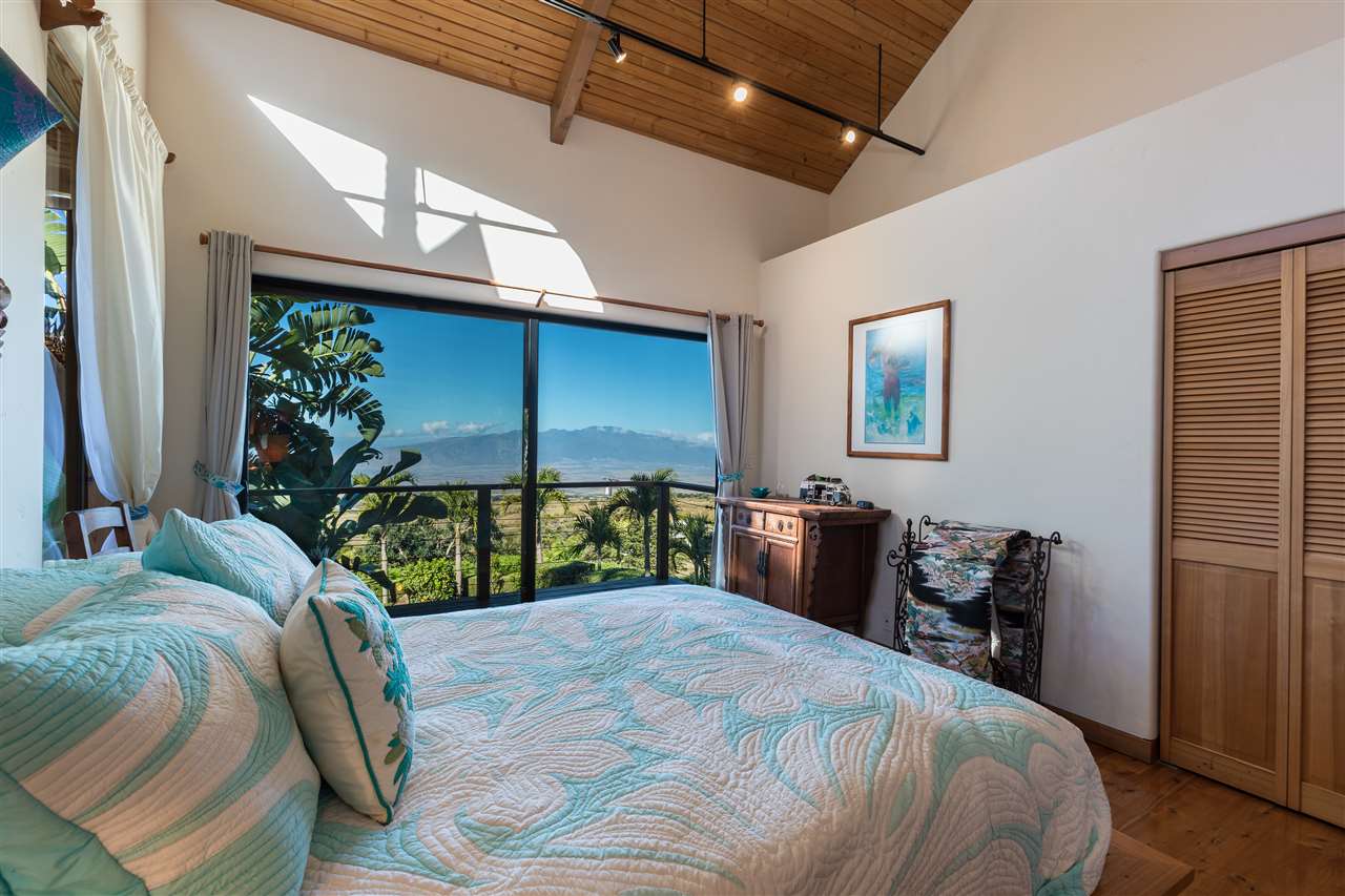 2623 Lower Kula Road Kula, HI 96790 - Photo 19 of 29 a bed room with a bed and a television