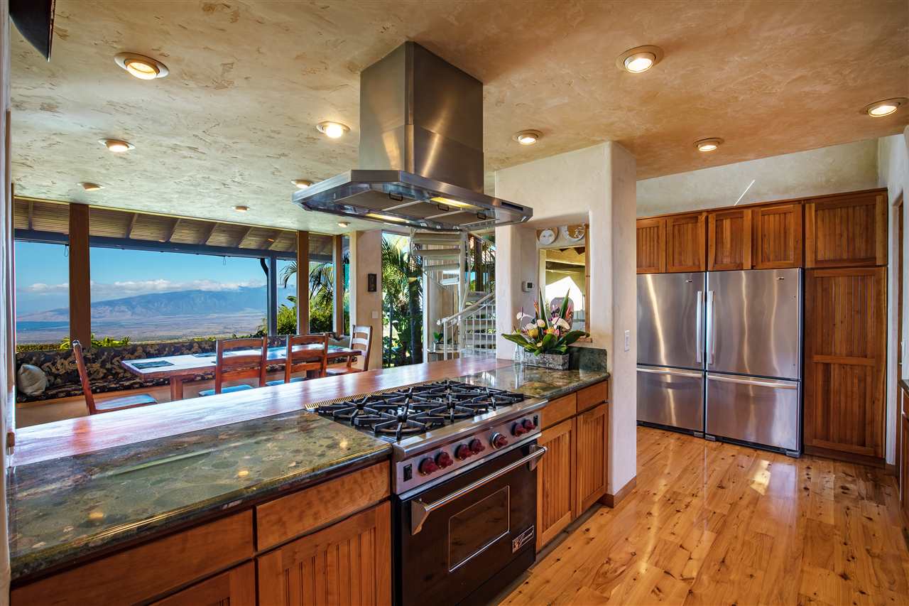 2623 Lower Kula Road Kula, HI 96790 - Photo 3 of 29 a kitchen with stainless steel appliances granite countertop a stove and a refrigerator