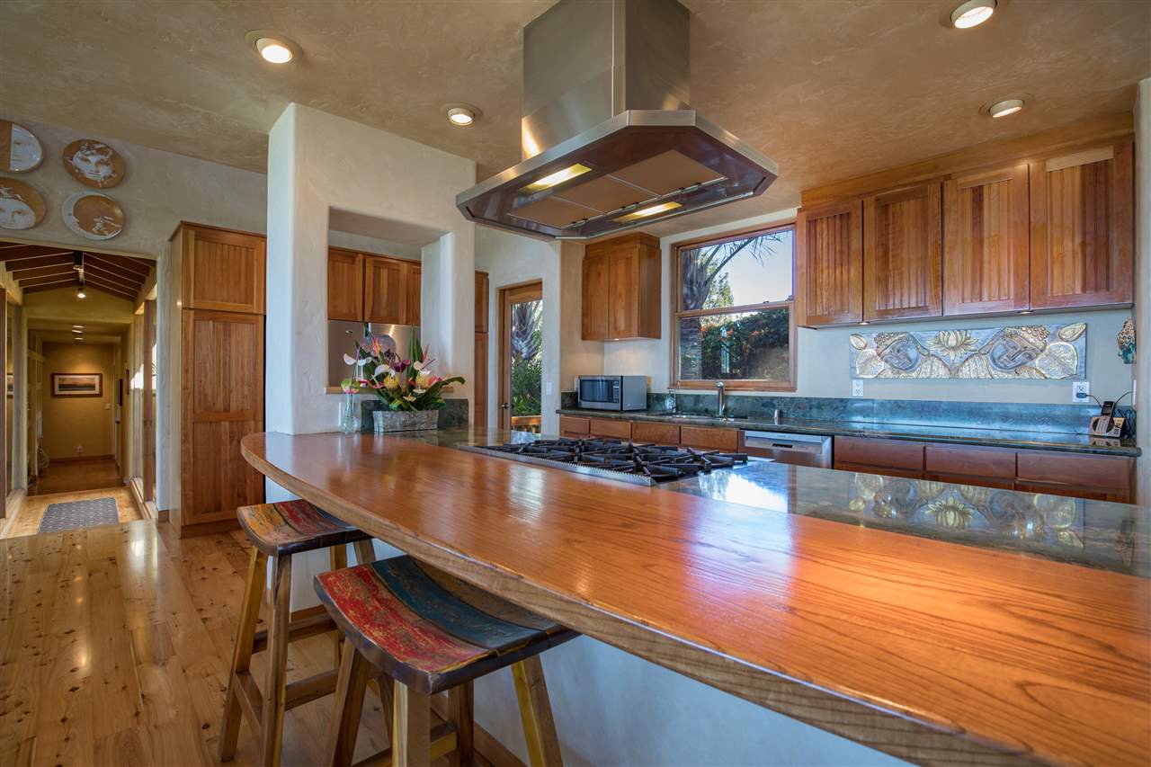 2623 Lower Kula Road Kula, HI 96790 - Photo 4 of 29 a kitchen with stainless steel appliances granite countertop a stove a refrigerator and a wooden cabinets