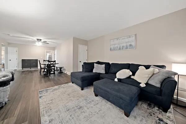 a living room with furniture and wooden floor