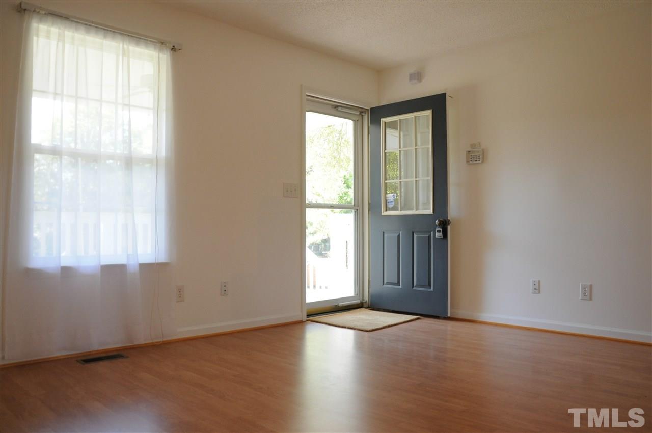 3353 Leonard Road Raleigh, NC 27610 - Photo 3 of 24 an empty room with wooden floor and windows