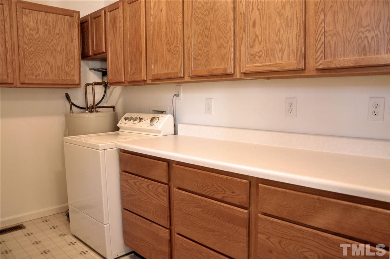 3353 Leonard Road Raleigh, NC 27610 - Photo 8 of 24 a view of storage and utility room with washer and dryer