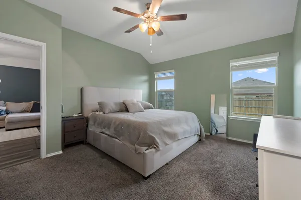 a bedroom with a bed and a chandelier