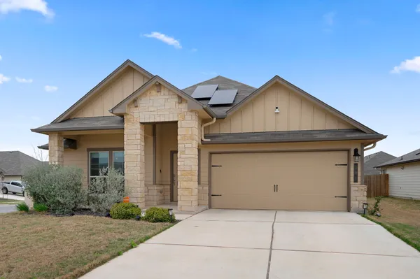 a front view of a house with garage