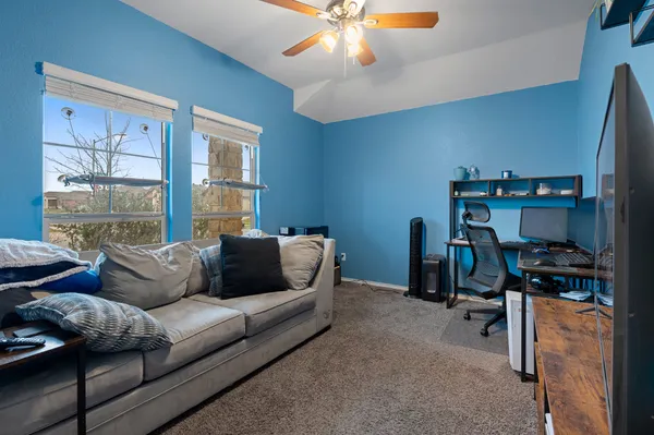 a view of a livingroom with a chandelier fan