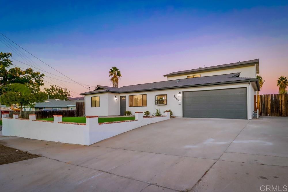 9495 Vomac Road Santee, CA 92071 - Photo 1 of 1 a front view of a house with a yard and a garage