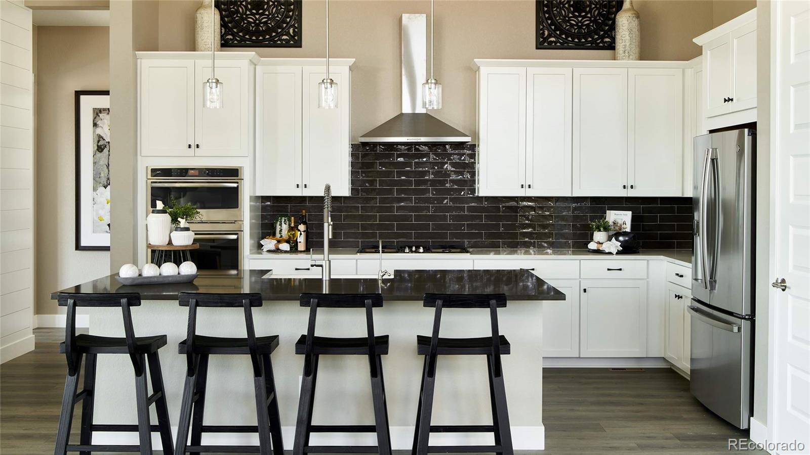 3867 Freestone Point Castle Rock, CO 80108 - Photo 11 of 38 a kitchen with stainless steel appliances a stove top oven and a refrigerator