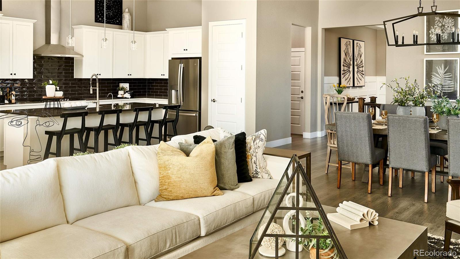 3867 Freestone Point Castle Rock, CO 80108 - Photo 13 of 38 a living room with furniture wooden floor and a view of kitchen