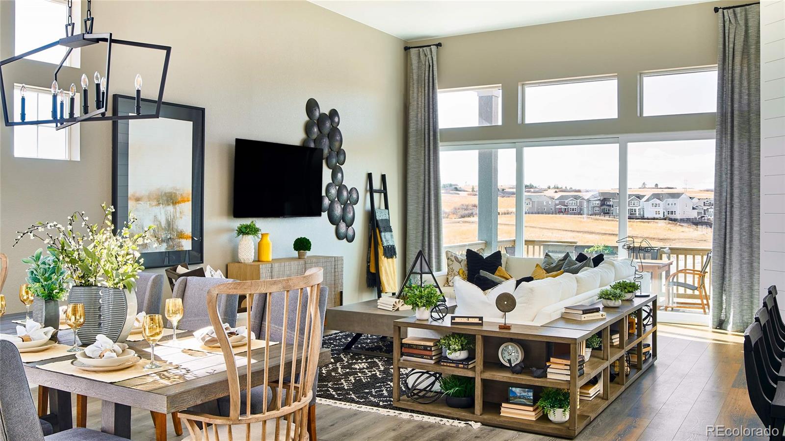 3867 Freestone Point Castle Rock, CO 80108 - Photo 15 of 38 a living room with furniture flat screen tv and a large window