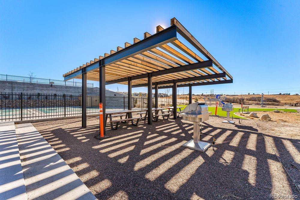 3867 Freestone Point Castle Rock, CO 80108 - Photo 24 of 38 a view of a patio with swimming pool table and chairs