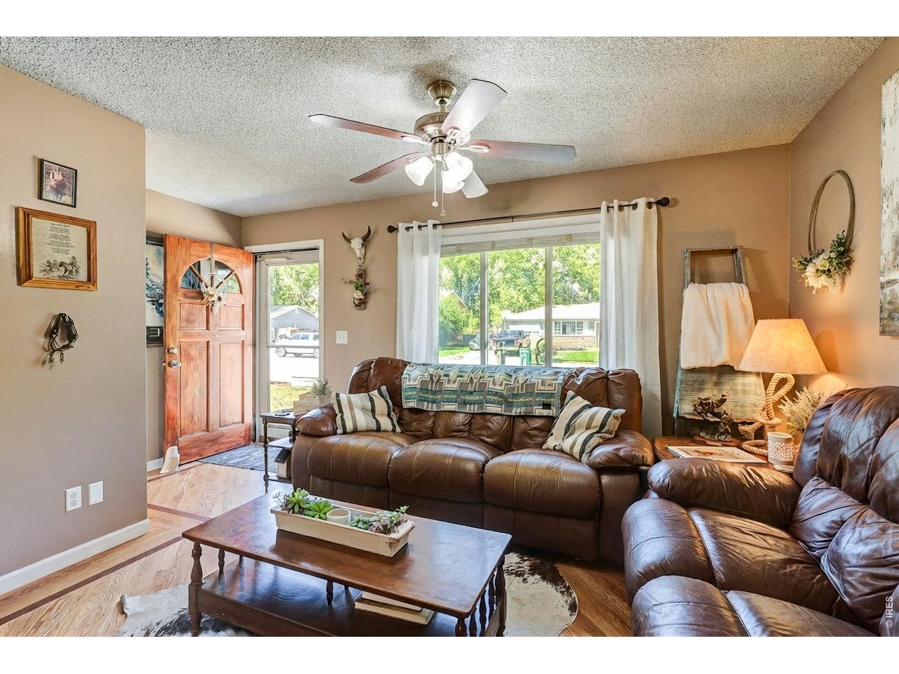 1130 2nd Street Road Eaton, CO 80615 - Photo 4 of 34 Enjoy the bright and welcoming living area accented by beautiful hardwood floors.
