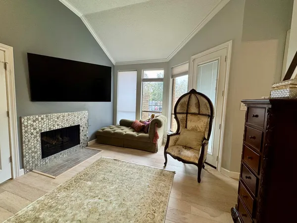 a living room with furniture flat screen tv and a fireplace