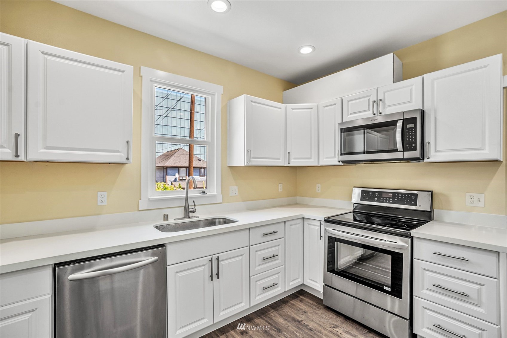 3113 Oakes Avenue Everett, WA 98201 - Photo 11 of 38 a kitchen with white cabinets stainless steel appliances and sink