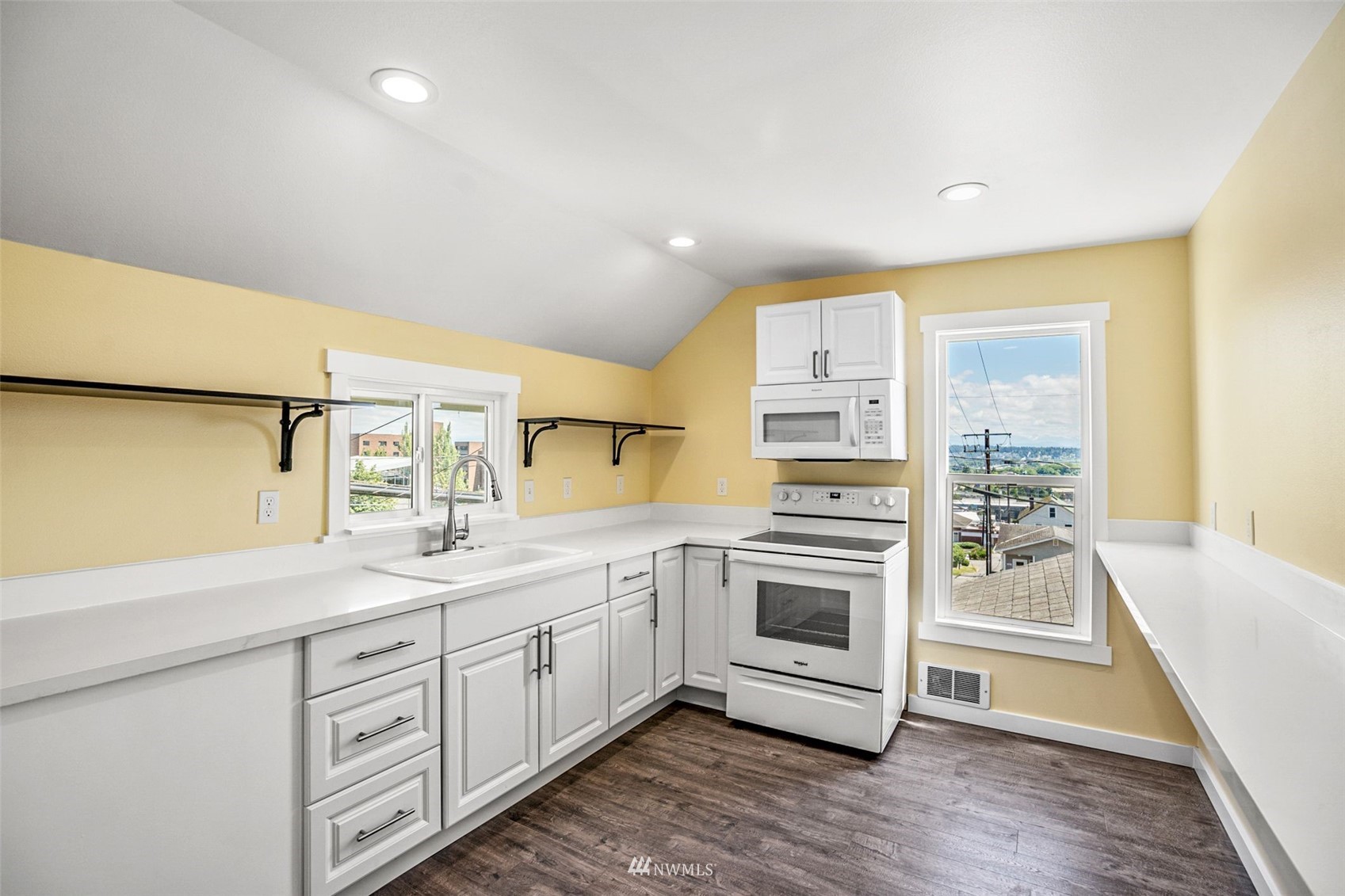 3113 Oakes Avenue Everett, WA 98201 - Photo 29 of 38 a kitchen with a sink cabinets stainless steel appliances and a window