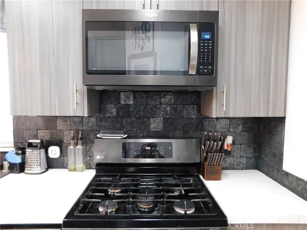 a kitchen with a stove and cabinets