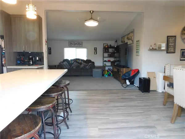 a living room with furniture a wooden floor and a window