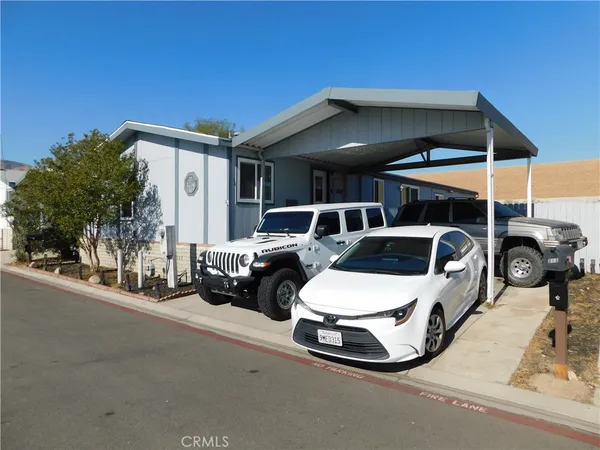 a view of a patio with table and chairs under an umbrella