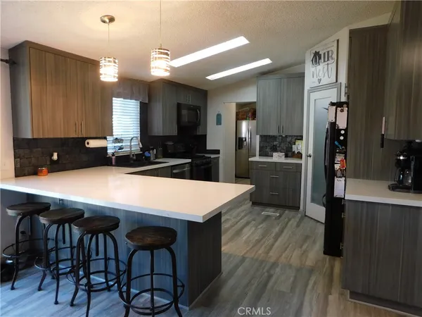 a kitchen with a table chairs refrigerator and cabinets