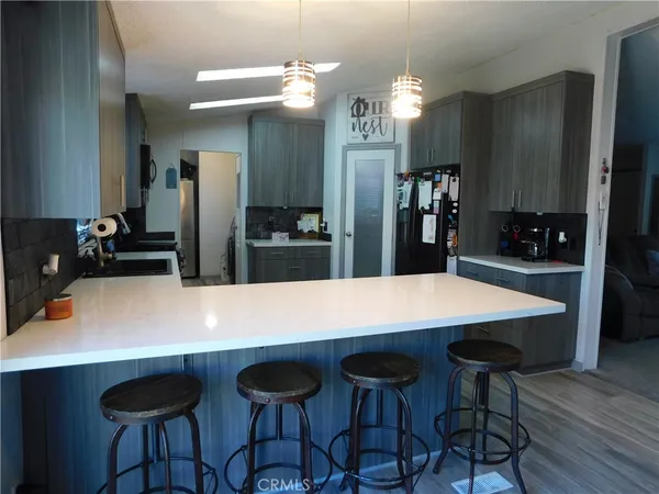 a large kitchen with a table and chairs
