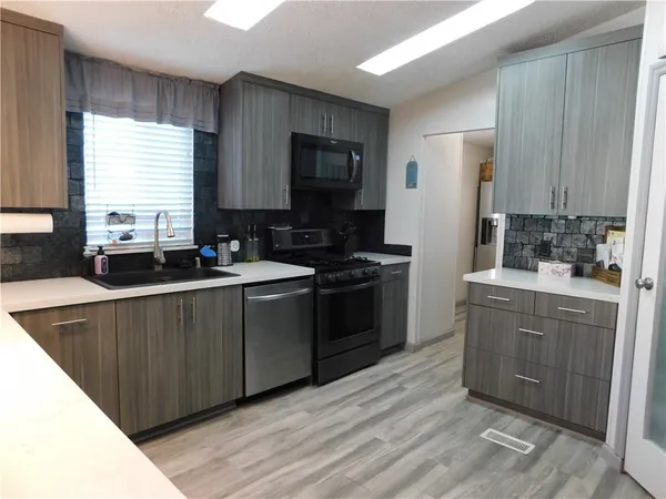 a kitchen with a sink stove and cabinets