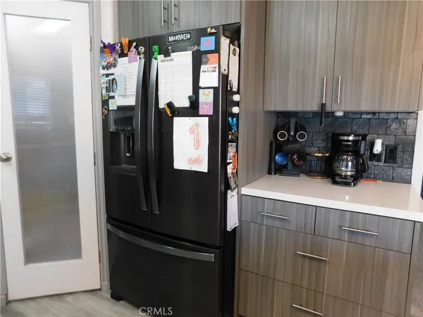 a kitchen with stainless steel appliances a refrigerator and a cabinets