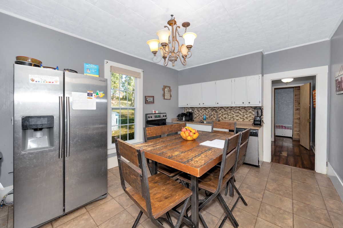 494 Case Road Prospect, TN 38477 - Photo 8 of 40 a kitchen with stainless steel appliances granite countertop a refrigerator a sink dishwasher a dining table and chairs with wooden floor