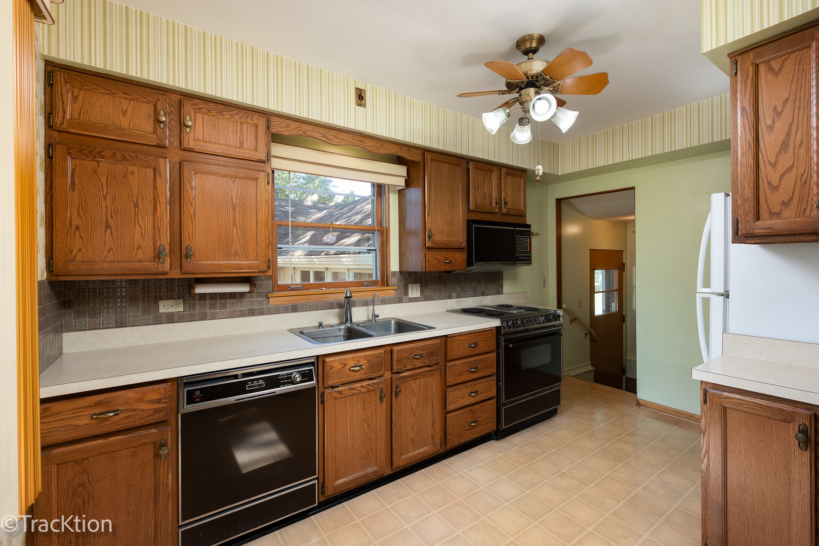 454 Andrus Road Darien, IL 60561 - Photo 6 of 20 a kitchen with stainless steel appliances granite countertop a sink cabinets and a stove