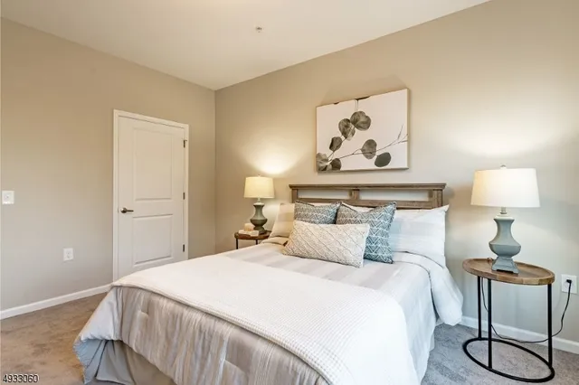 a bedroom with a bed and lamp